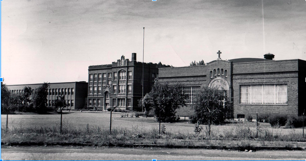 The original classroom building and field house are shown in this early picture of Catholic Central/ Bishop Noll