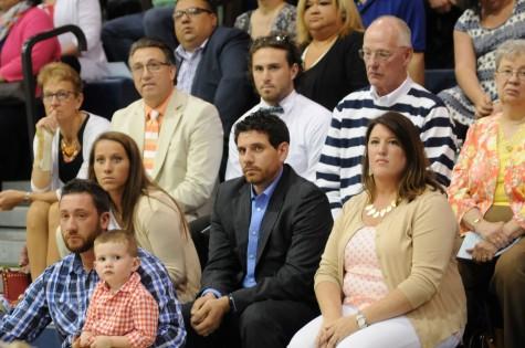 Kurt Bentley, son of Mr. Larry Bentley, and 2000 BNI graduate, talks to the Bishop Noll family at the 2015 commencement ceremony about the Larry Bentley scholarship. 