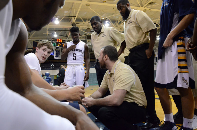 During a timeout in the 4th quarter, head coach Josh Belluomini takes a minute to regroup with the team before sending them back out to battle Illiana Christian on Dec. 8.