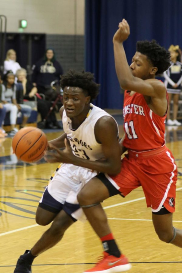 Challenging first game for the Boys warrior team against Munster boys                                                             basketball team. Brendan Scott passes by Munster defender #11 Dante Spina to try and help the                                                                                    Warriors win the first game of the season. 