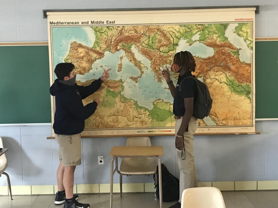 Students Ethan Lopez and Kayode Olaoye talking over geography and history.