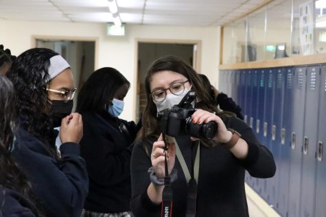 Dominiak assisting photography student