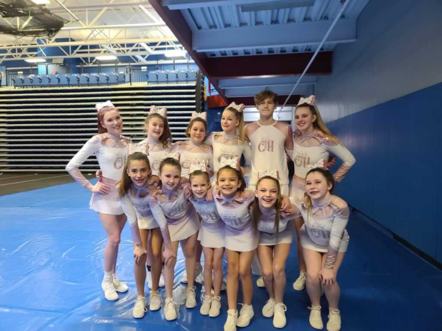 Freshman Kaylie Dowd poses with her CTH cheer team. After spending a day on the mat, it was all smiles from the team. Dowd is pictured top row, second on the left.