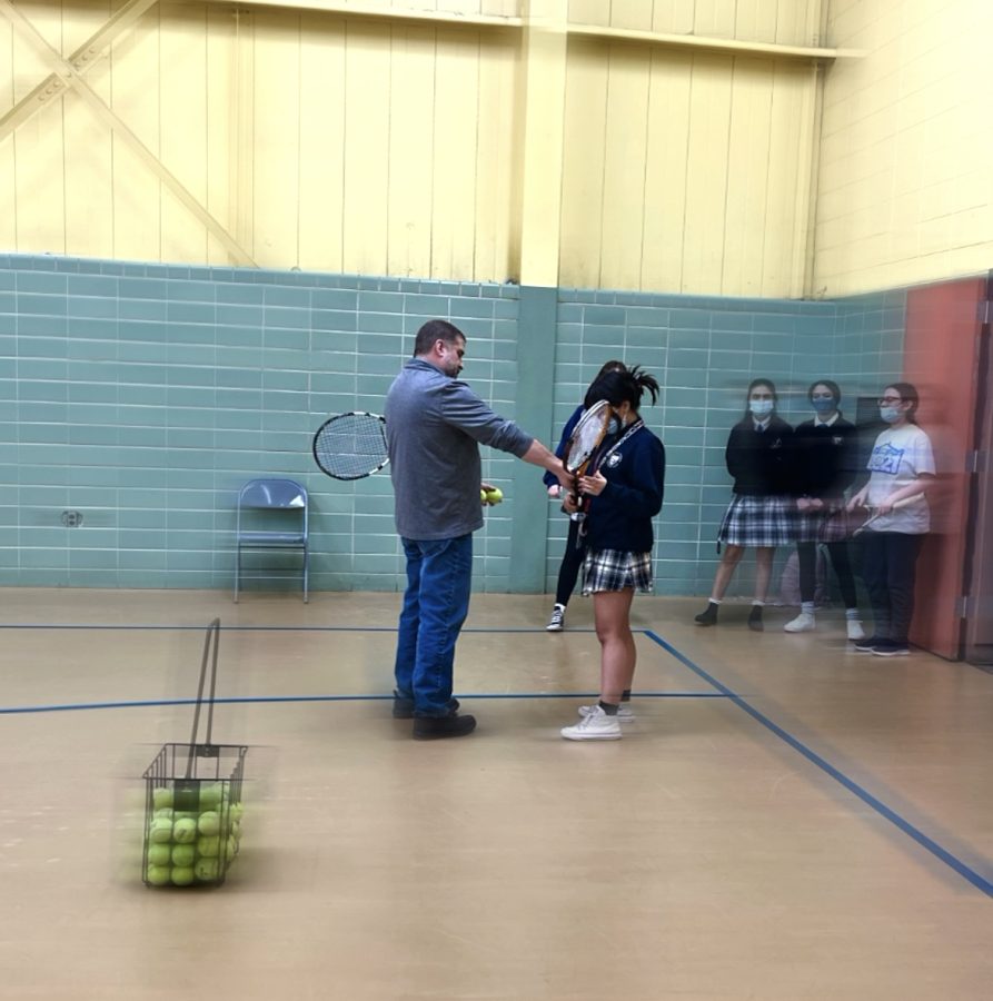 Coach Biaz correcting Junior Aranza Toral-Arellano’s racket grip. 
