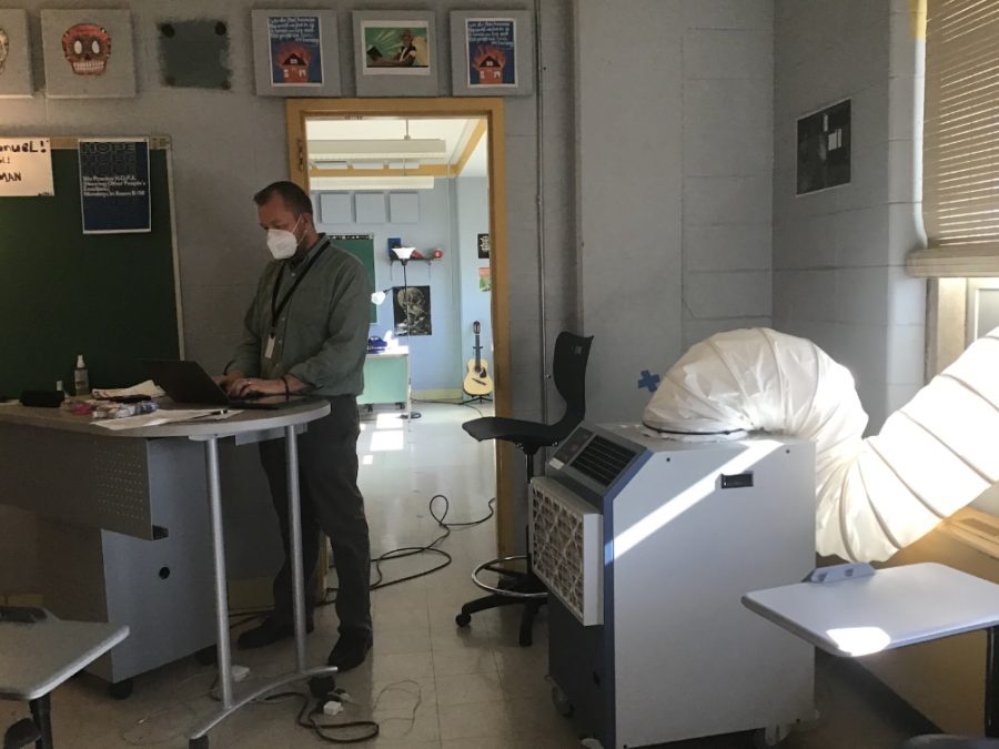 Mr. Ed Watrobka, sophomore English teacher, instructs in front of one of the new air conditioning units. All classrooms will be outfitted with air conditioning by the beginning of the next school year. 

