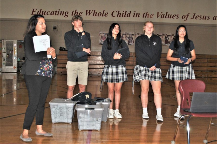 Come one, Come all. - (Left to Right) Mrs. Carmen Ontiveros, junior Erik Shelton,junior Painalli Patino, sophomore Molly Whelan and senior Maria Emelia Quiroga look fixedly towards the students at St. Thomas More School in Munster, IN. During the month of October, student ambassadors traveled out to give presentations to catholic middle schoolers in the area about a future at BNI. 
